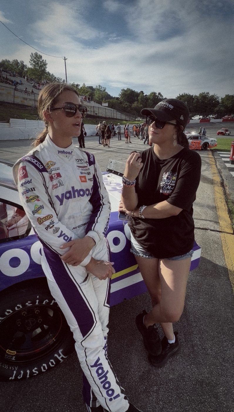 Madison talking with a driver on pit road