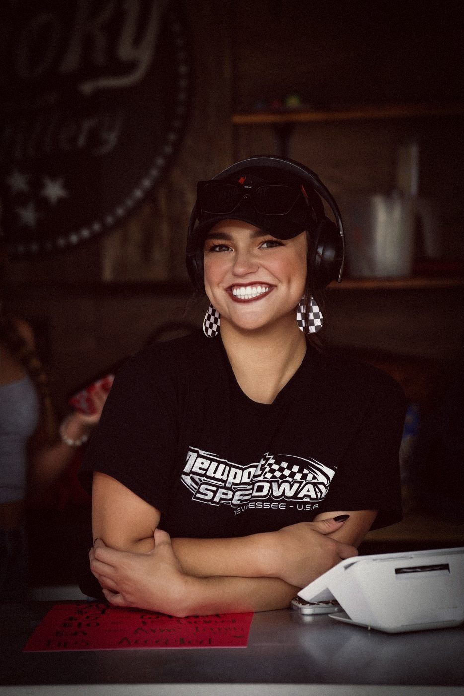 Madison in a Newport Speedway shirt with a headset